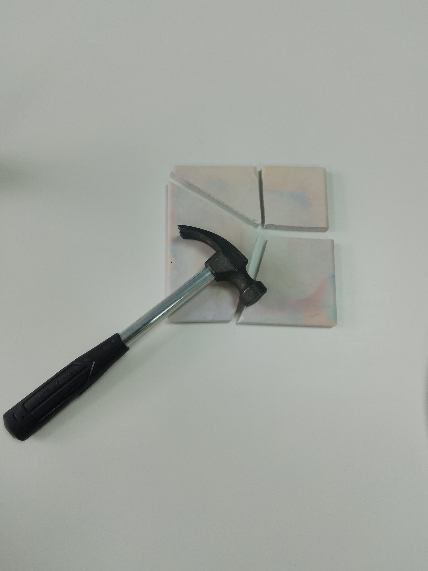 Hammer on a broken tile