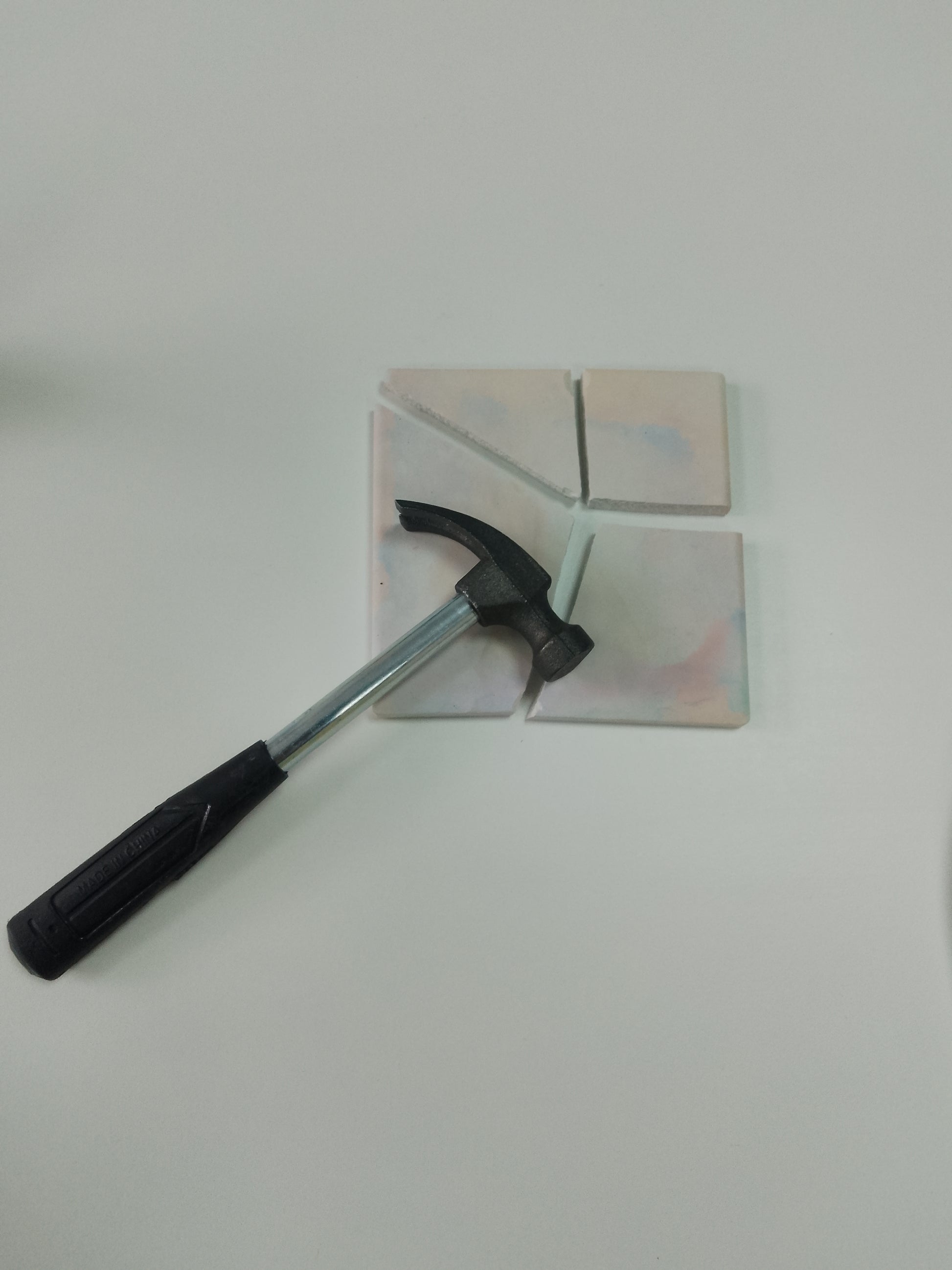 Hammer on a broken tile